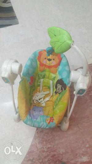 Baby's White, Blue, And Yellow Bouncer Seat