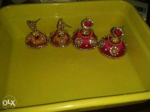 Each Pairs Of Red And Gold Jhumka Earrings