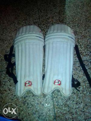Two White Leather Shin Guards