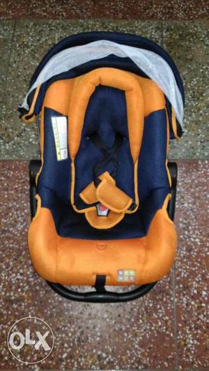 Baby's Orange And Blue Car Seat Carrier