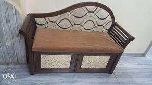 A small bedroom sofa with storage and seating of