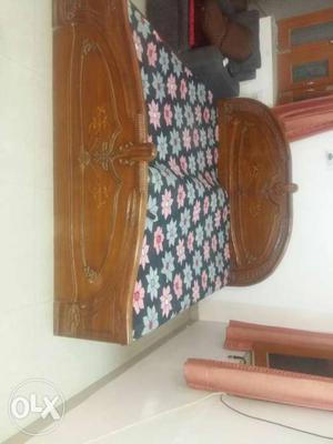 Brown Wooden Bed Frame With Floral Mattress