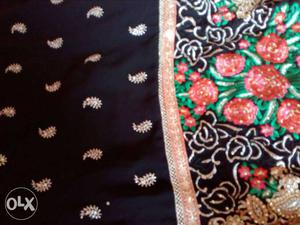 Black, Red, And Green Floral Textile