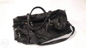 Black leather bag for travelling.