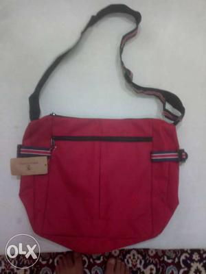 Brand new sling bag. Maroon in colour with 4