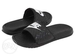 Pair Of Black-and-white Nike Slide Sandals.