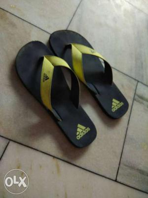 Pair Of Black-and-yellow Adidas Flip Flops