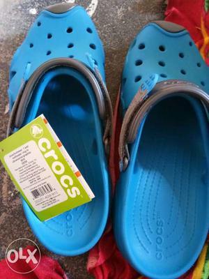 Pair Of Blue-and-black Crocs Sandals