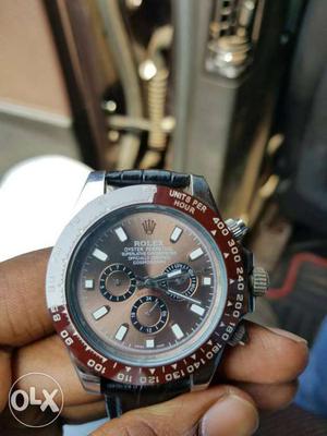 Round Silver And Red Rolex Chronograph Watch With Black