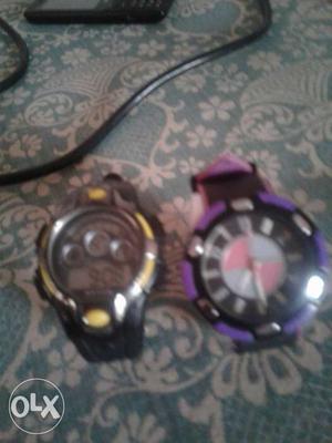 Two Round Purple-and-black And Yellow-and-gray Watches With