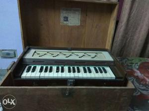 Harmonium with wooden box.