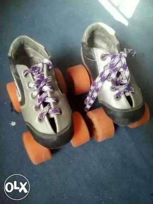 Pair Of Gray And Black Roller Blades