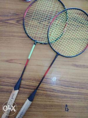Two Grey Badminton Rackets