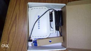 White And Blue Net Gear Router In Box