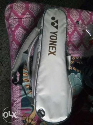 White Yonex Sports Bag with yonex arcsaber 002 badminton
