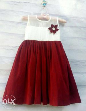Red and white frock made of silk material