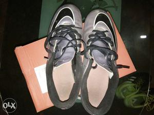 Black-and-gray Nike football shoes