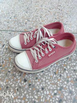 Pair Of Pink Crocs Low Top Sneakers