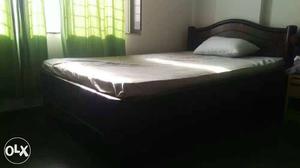 Black Wooden Bed Frame With White Bed Mattress