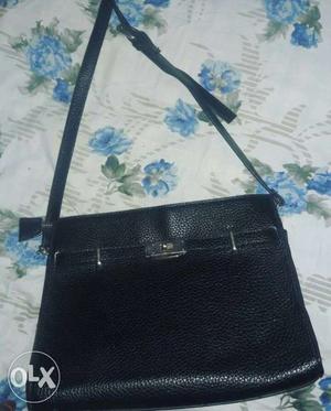 Black lather sling bag. still in good condition