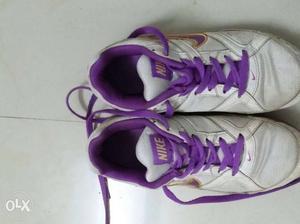 Pair Of Purple And White Nike High Top Sneakers