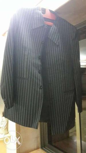 Three piece black suit with white stripes. Price