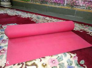 A red yoga/exercise mat of 1.5m. Very comfortable