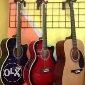 Three Brown Acoustic Guitars