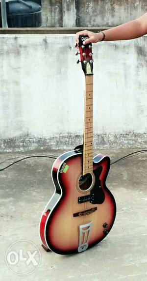 Black, Red, And Brown Cutaway Acoustic Guitar