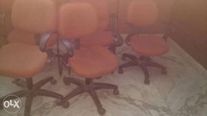 Four Black-and-orange Office Chairs, /- each.