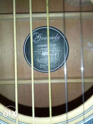 Granada acoustic guitar with tuner and 2 years