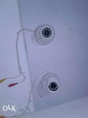 Two White Dome Security Cameras