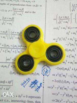 Yellow Fidget Hand Spinner Toy; Mathematical Worksheet
