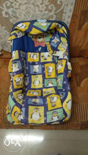 Baby's Blue, Yellow And White Penguin Print carry cot