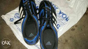 Pair Of Black And Blue Adidas Cleats