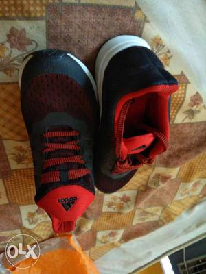 Pair Of Black And Red Adidas Snakers