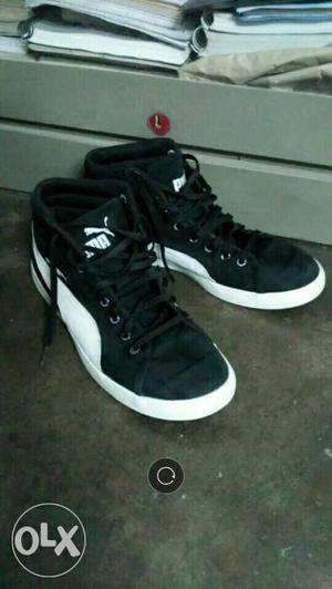 Pair Of Black-and-white Puma High Top Sneakers