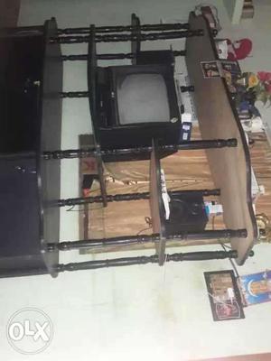 Black CRT Television And Brown Wooden Tv Hutch