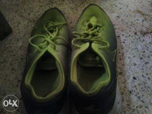 Pair Of Green-and-black sports shoes