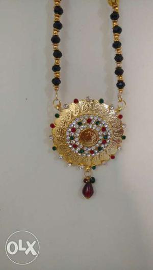 Round Gemstone Embellished And Gold Pendant