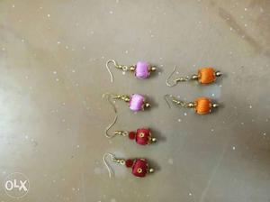 Three Pairs Of Red, Purple And Orange Thread Hook Earrings