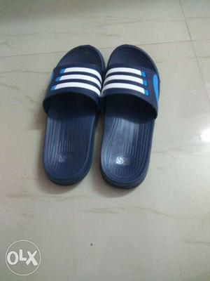 Pair Of Black White And Blue Slide Sandals