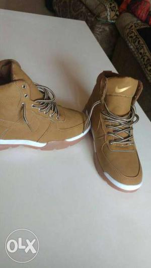 Pair Of Brown Nike High Top Shoes