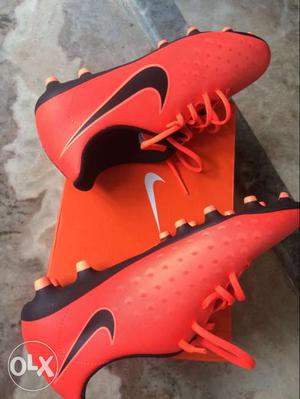 Pair Of Orange-and-black Nike Cleats With Box
