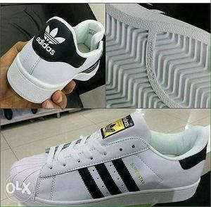 Unpaired Of Black And White Adidas Superstar