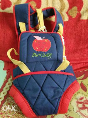 Baby's Red, Yellow And Blue Carrier