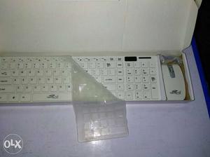 White Wireless Computer Mouse And Keyboard In Box
