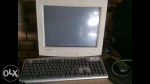 White CRT Computer Monitor With Black Keyboard And Mouse Set