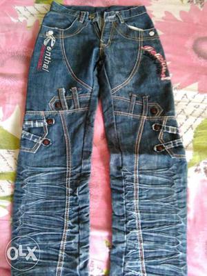 Apair of blue and black jeans for boys size 40