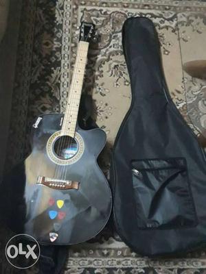 Black Acoustic Guitar And Black Bag